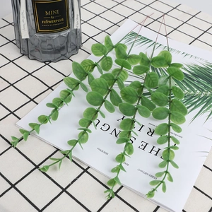Artificial eucalyptus branches in dusty green on a checkered tablecloth INS style decor
