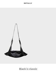 Detailed view of black soft leather crossbody bag with minimalist wing-shaped structure
