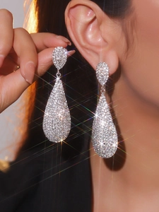 Macro detail of long teardrop earrings with luxury sparkling rhinestones on model
