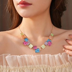 Close-up of colorful enamel square pendant necklace on model showing elegant fit