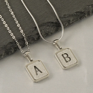 Fashionable stainless steel pendant necklaces with A and B initial letters on silver plates