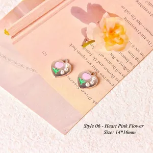 Macro shot of 14x16mm heart-shaped flower charms with pink petals and pearl accents