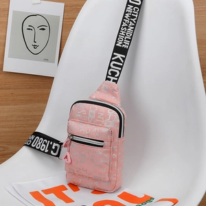 Detail of pink fashion chest bag with patterned print and adjustable wide strap