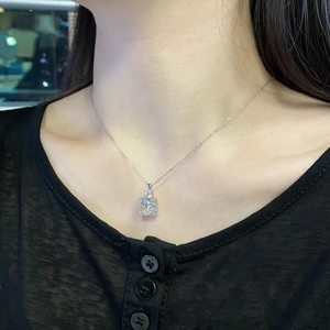 Close-up of S925 silver necklace with emerald cut cubic zirconia pendant on model neck