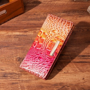 Red and yellow gradient long wallet with embossed crocodile texture on wood background