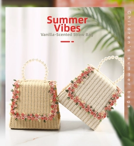 Detailed view of handmade woven straw bag featuring pink flower embroidery and pearl handle