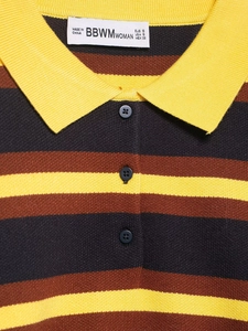 Close-up of striped knit polo neck with yellow ribbed collar and black buttons