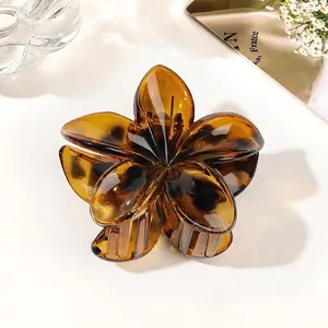 Detail of amber translucent floral hair claw clip made of resin with metal spring
