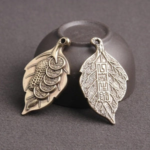 Antique bronze lucky leaf pendant with five emperor coins showing both sides of the charm