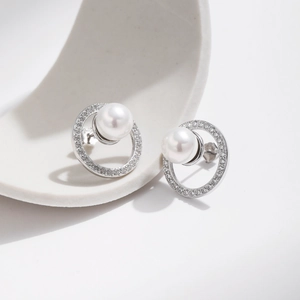 Elegant S925 silver stud earrings with sparkling diamonds and white pearl on ceramic tray