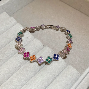 Macro view of silver clover bracelet with colorful zircons in a jewelry box