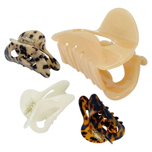 Detail of assorted acetate hair claws in cream, tortoiseshell, and leopard patterns