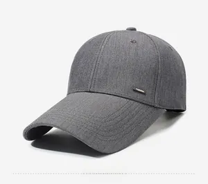 Close-up of dark grey baseball cap with fine twill texture and metal FASHION side label