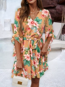 Detail of V-neck floral chiffon dress with ruffled sleeves and matching waist tie