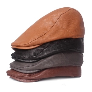 Classic British style leather flat caps for men shown in four assorted vintage colors