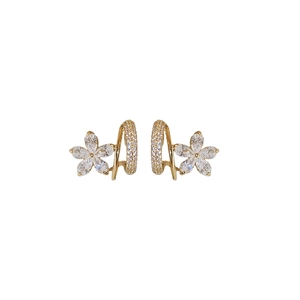 Elegant gold C-shaped flower earrings with sparkling cubic zirconia on white background