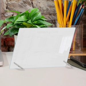 Clear acrylic weekly planner board with metal stands on a clean desktop workplace