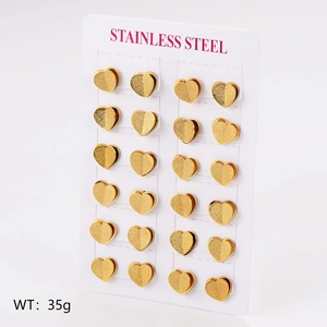 Set of 12 pairs of golden heart-shaped stainless steel stud earrings on display board