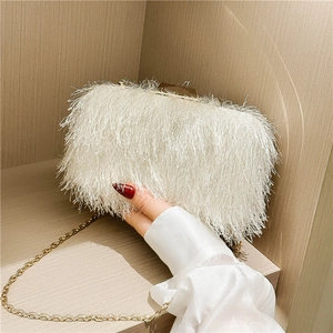 Elegant white feather evening clutch with gold chain and metal clasp for formal events