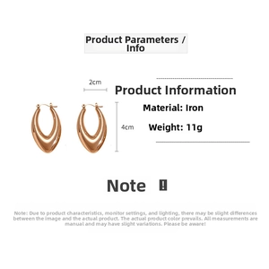 Detail view of smooth teardrop hollow hoop earrings in polished gold finish