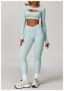 Detail of light blue yoga set featuring a cutout long-sleeve top and crossover high waist leggings