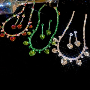 Detailed close-up of heart-shaped zircon necklace and earring sets in multiple colors
