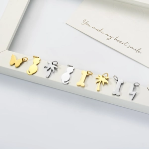 Polished stainless steel charms featuring cat, butterfly, and tree shapes in gold and silver