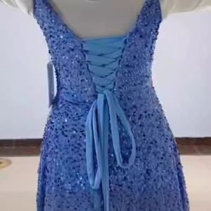 Sparkly light blue sequin A-line prom dress featuring an elegant lace-up corset back