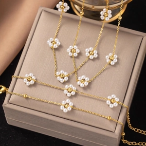 Floral pearl necklace with gold finish, delicate daisy charms and adjustable lobster clasp