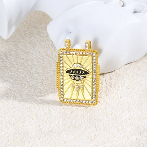 Macro shot of gold-plated copper UFO pendant with black enamel and clear rhinestones