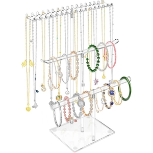 Three-tier clear acrylic jewelry stand detail with hooks for necklaces and bracelets