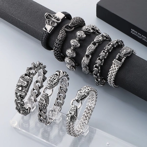 Detail of vintage snake-head bracelets in distressed steel with intricate scale textures