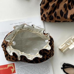 Leopard print cosmetic pouch with pearl drawstring and soft velvet texture in top view