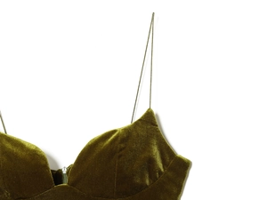 Detail of olive green velvet dress with spaghetti straps and front zipper closure