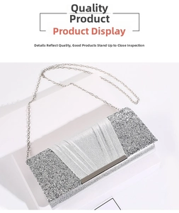 Detail view of sparkly silver evening clutch bag with metallic folds and chain strap