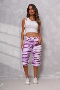 Close-up of purple and white tie-dye denim shorts with functional pockets and casual fit