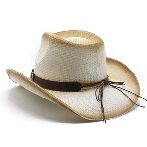 Close-up of a hand-woven straw cowboy hat with brown gradient spray-painted edges