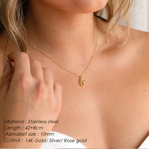 Close-up of minimalist stainless steel 'f' letter pendant necklace on a model's neck