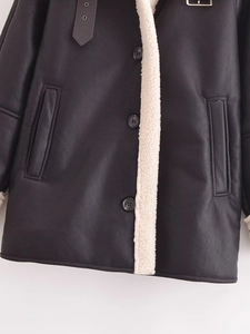 Detail of faux leather shearling jacket with buckle collar and plush lining texture