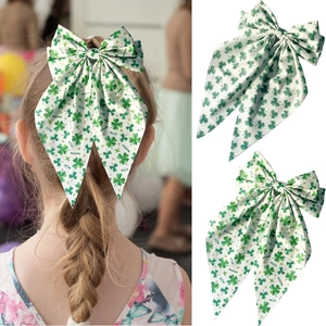 Detail of St. Patrick’s Day green shamrock bow hair clip with elegant long ribbons