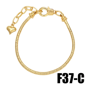 Detail of a gold plated snake chain bracelet with heart pendant and lobster clasp closure
