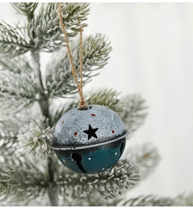 Blue matte metal star bell with rustic finish hanging on frosted Christmas tree