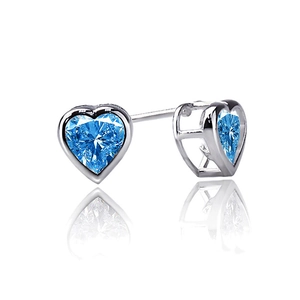 Macro detail of heart-shaped royal blue crystal earrings in polished silver bezel setting