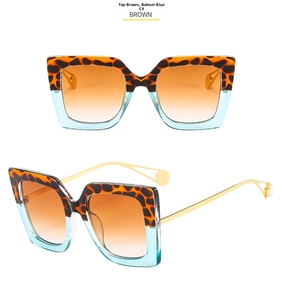 Detail of oversized sunglasses with leopard blue frames and pearl-tipped gold temples