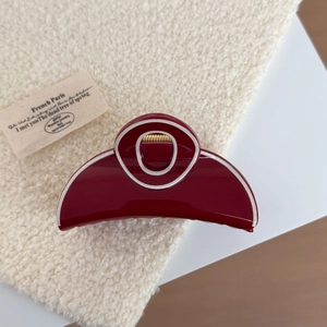 Elegant wine red acetate hair claw clip with white piping detail on cream fleece