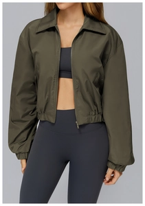 Detail of army green windproof jacket with elastic cuffs and zippered sports design
