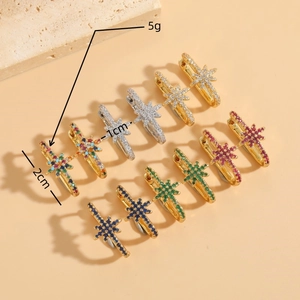Gold starburst earrings with colorful crystals and measurement details on beige background