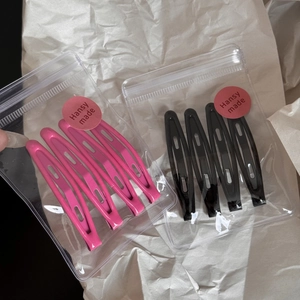 Detail of candy color metal hair clips set in branded plastic zipper packaging