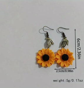 Detailed view of yellow flower earrings with copper hooks and leaf accents showing dimensions