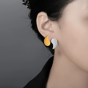 18k gold plated yin yang stud earrings set in gold and silver stainless steel on model
